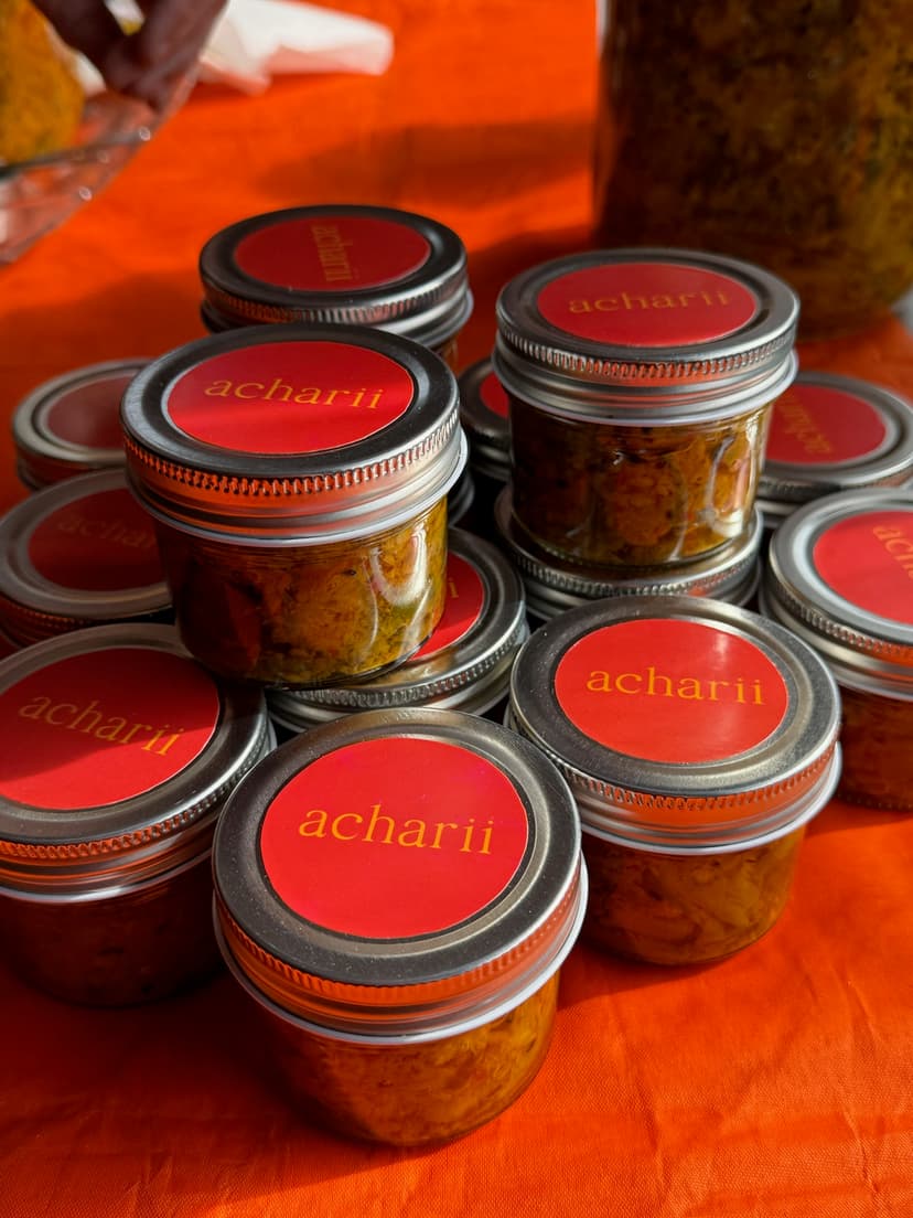 A collection of achaar jars with vibrant colors and rich textures, showcasing the bold flavors of acharii products.